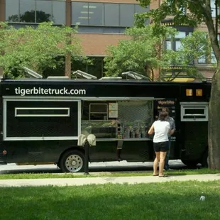 a man standing in front of a food truck