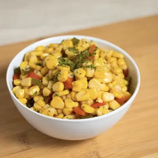 a corn salad in a white bowl