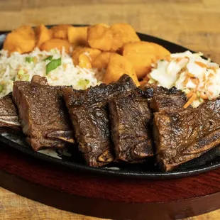 a plate of ribs and coleslaw