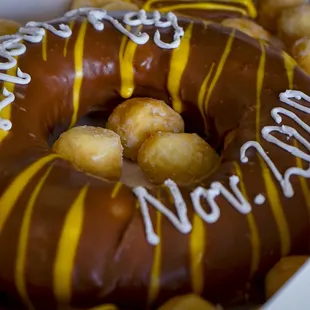 a chocolate donut with a happy birthday message