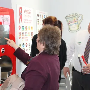 a man and a woman standing in front of a vending machine