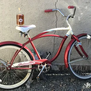 a red bicycle parked against a wall