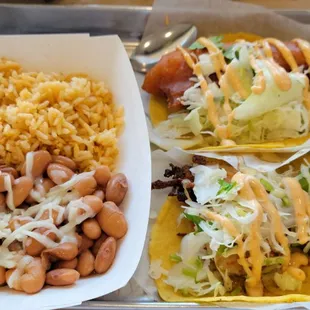 Fried fish taco on top and shrimp on bottom.  Would have preferred grilled option but both ok. Rice and beans were flat flavor-wise.