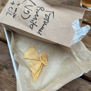 a bag of tortillas and a glass of beer