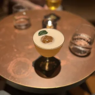 a person sitting at a table with a drink