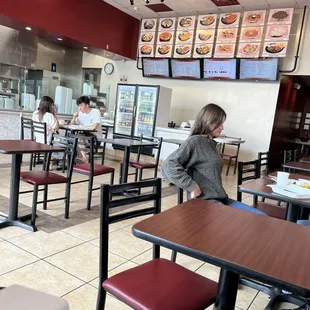 Restaurant space, there are two outdoor tables with two chairs each.