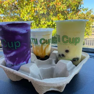 two drinks in a carton on a table