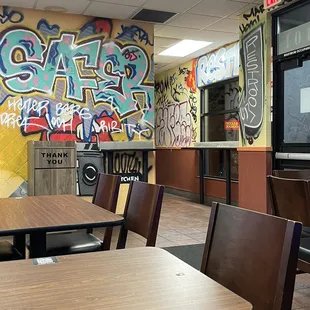 a restaurant with graffiti on the walls