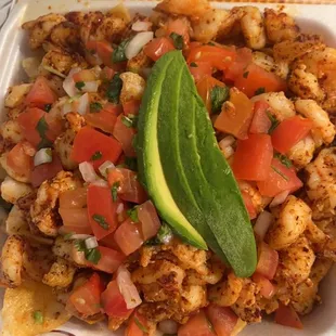 Made to order Diablo, shrimp nachos, whole beans, pico de gallo avocado.