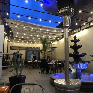 a patio with a fountain