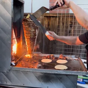 a man cooking food on a grill