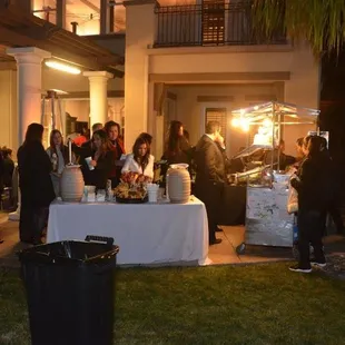 a group of people standing around a table