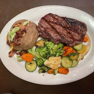 House rib eye ($21.95 USD 8oz) with loaded potato ($3.00 USD)