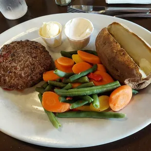 Hamburger Steak dinner with baked potato and vegetables.