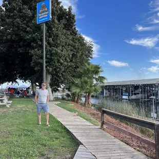 a woman walking on a boardwalk