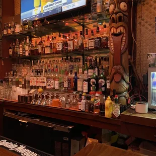 a tiki bar with a large screen tv