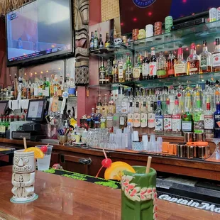 a tiki bar with a large television
