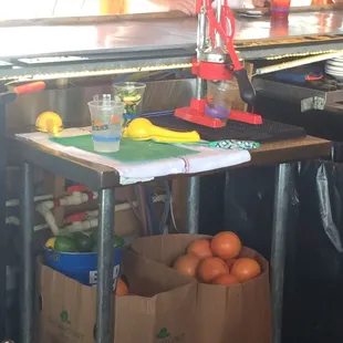a woman standing behind a counter with a variety of food items on it