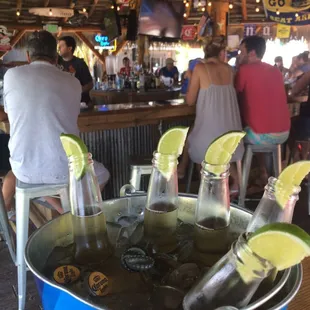 a bucket filled with ice and lime slices