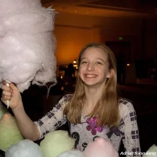 She is enjoying a Big Kahuna sized cotton candy!