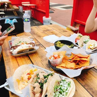 a table of tacos and chips