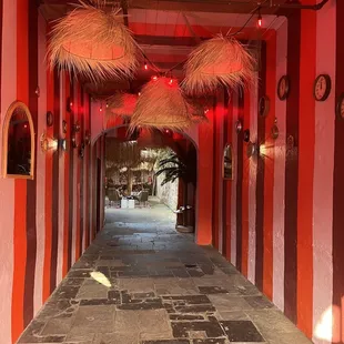 a walkway with red lights