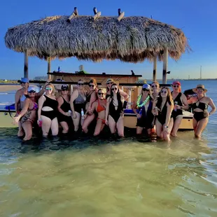 a group of women in bathing suits in the water