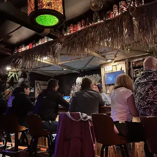 a group of people sitting at a bar