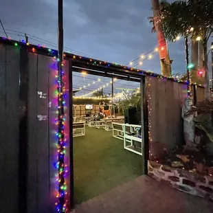 a view of a patio area with colorful lights