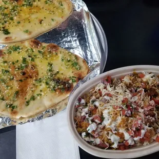 Garlic naan. Bowl with rice, steak, chicken, cheese and pico