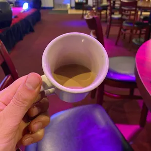 a person holding a cup of coffee