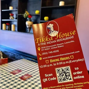 a hand holding up a restaurant menu