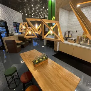 a dining area with a wooden table and stools