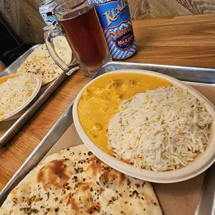 Butter Chicken with rice and a garlic Naan alongside a Klaus Oktoberfest.