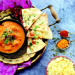 a plate of naan bread and a bowl of dip