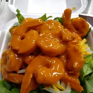 Buffalo shrimp on small salad.