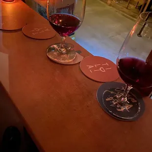 a row of wine glasses on a bar