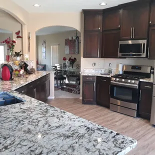a kitchen with granite countertops and stainless steel appliances