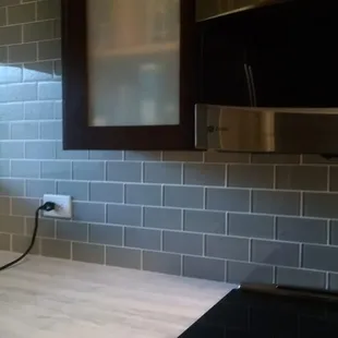 Glass subway tile backsplash