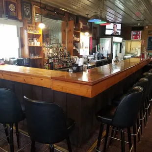 a bar with black chairs