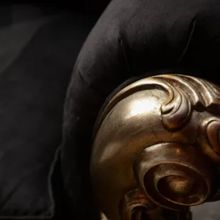 a close up of a gold chair