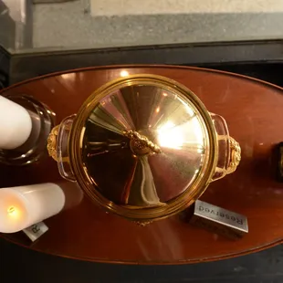 a coffee table with candles and a clock