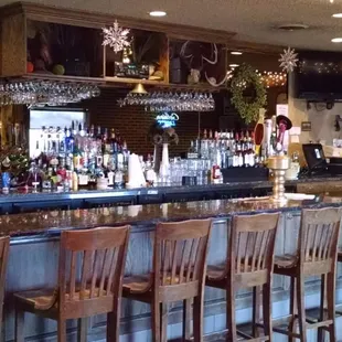 a bar with wooden chairs