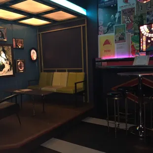 a room with a bar and chairs