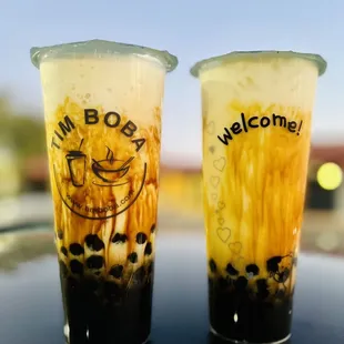 two cold drinks sitting on a table