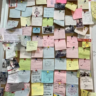 a cork board covered in post it notes