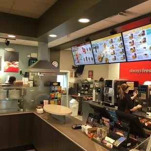 a woman ordering food in a fast food restaurant