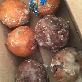 a box of doughnuts with sprinkles