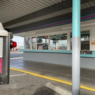 The exterior of a good old-fashioned drive-inn where you place the order from your car and they bring it to you.