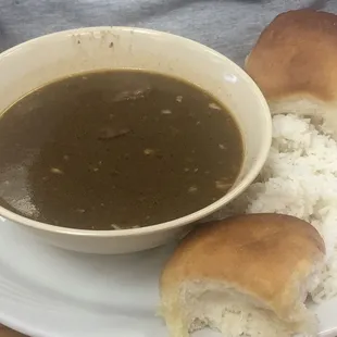 a bowl of soup and rolls